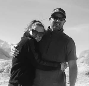 A man and woman hugging in the snow.